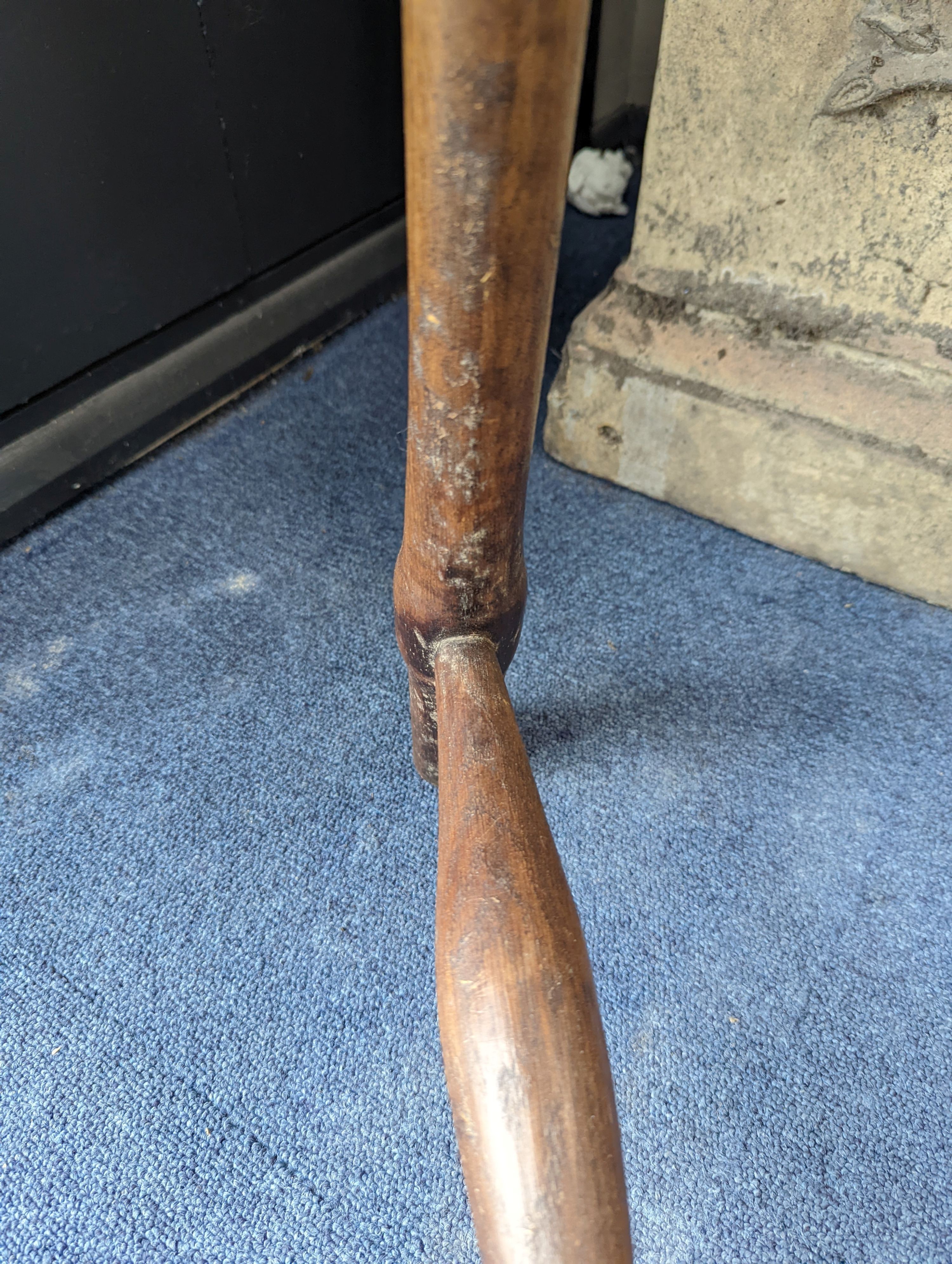 A circular burr elm and ash primitive cricket table with T shaped stretcher, diameter 44cm, height 61cm